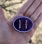diamond tapered baguette charms hanging from 14k yellow gold huggie hoops. The diamond baguettes are removable. Allowing you to wear the earrings multiple ways.