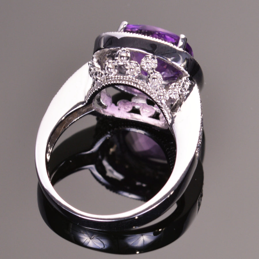 cushion amethyst ring with diamond halo in white gold.
