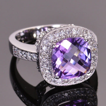 cushion amethyst ring with diamond halo in white gold.