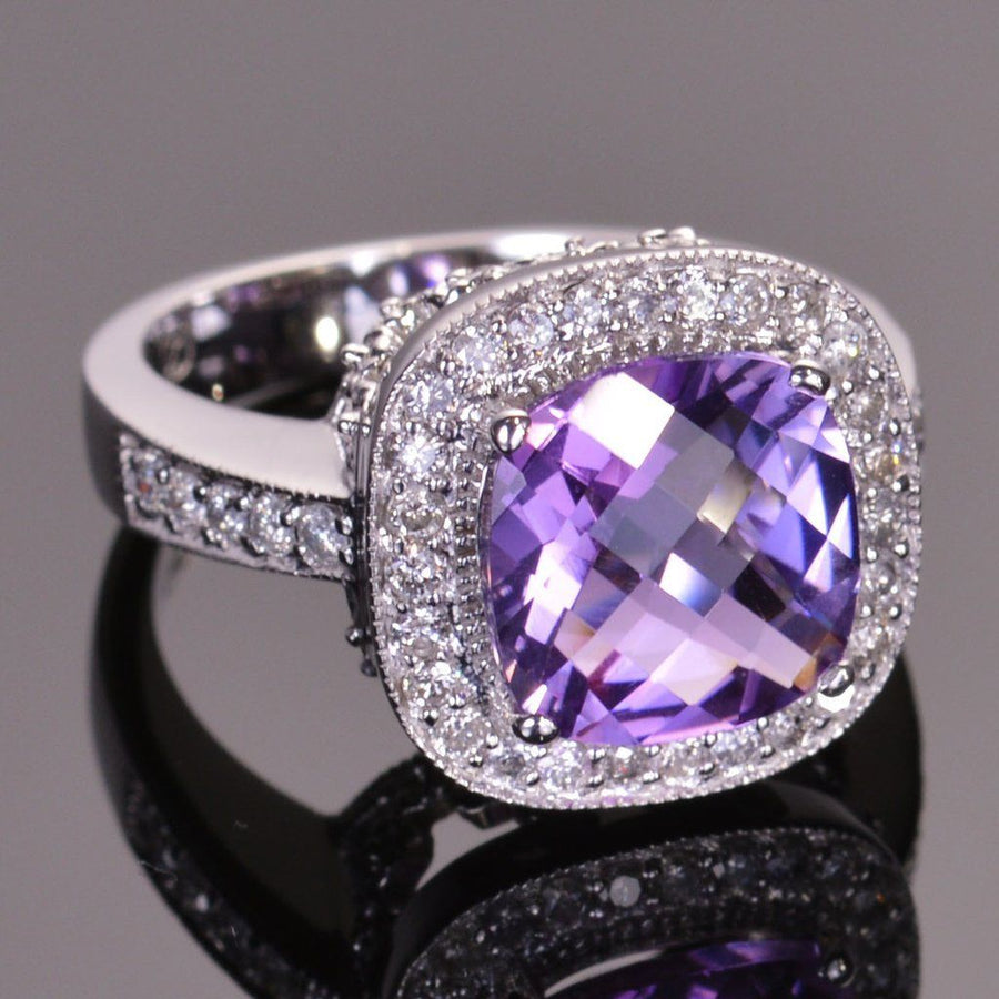 cushion amethyst ring with diamond halo in white gold.