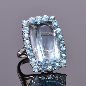 aquamarine ring with blue zircon halo in white gold