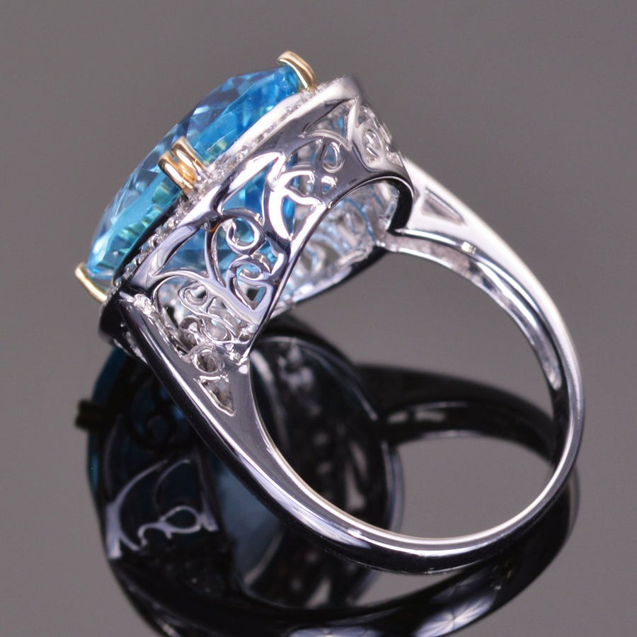 oval blue topaz ring with white sapphire halo in white gold